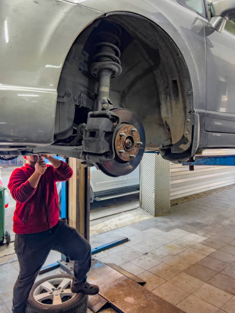 istock Technician working on car brake and shock absorber 1490449530