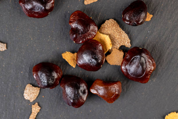istock brown tamarind seeds on the table, scattered seeds 1490449783