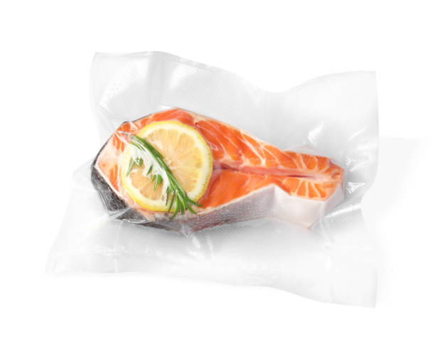 istock Salmon with lemon in vacuum pack on white background, top view 1490450632