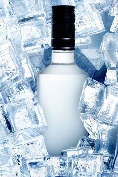 istock Bottle of vodka and ice cubes, closeup view 1490451766