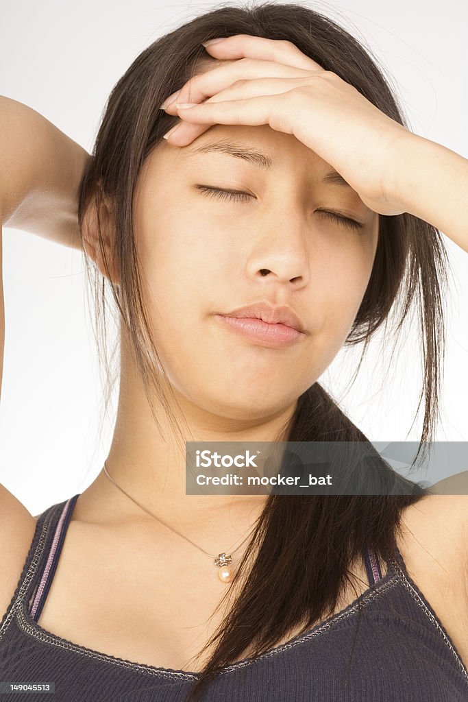 Young attractive woman suffering from headache Young female squeezing her head apparently having headache 18-19 Years Stock Photo