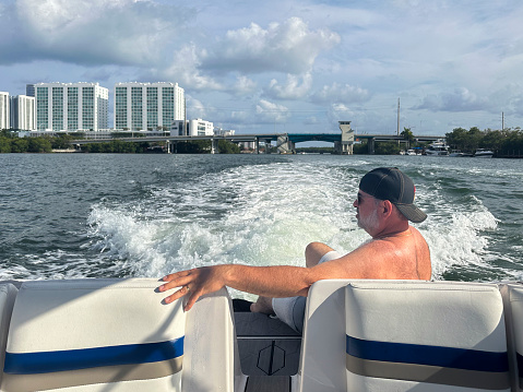 Adult man sailing in a motor boat, North Miami, Florida, USA