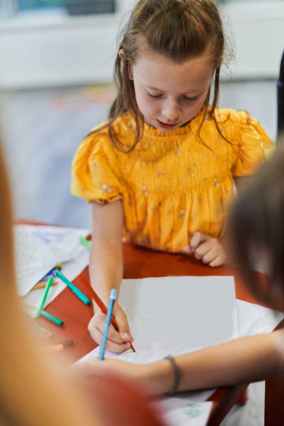 istock Creative kids sitting in a preschool institution, draw and have fun while they get an education 1490460195