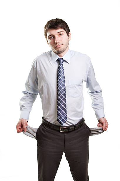 Sad and broke businessman with empty pockets Sad and broke business man with empty pockets empty pockets stock pictures, royalty-free photos & images