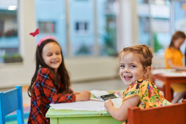 istock Creative kids during an art class in a daycare center or elementary school classroom drawing with female teacher. 1490461263