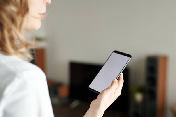 istock Woman using smartphone to call cleaning service 1490462302