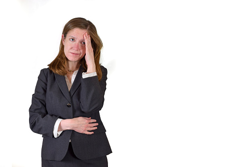 Closeup of a stressed or depressed business woman isolated on a white background.