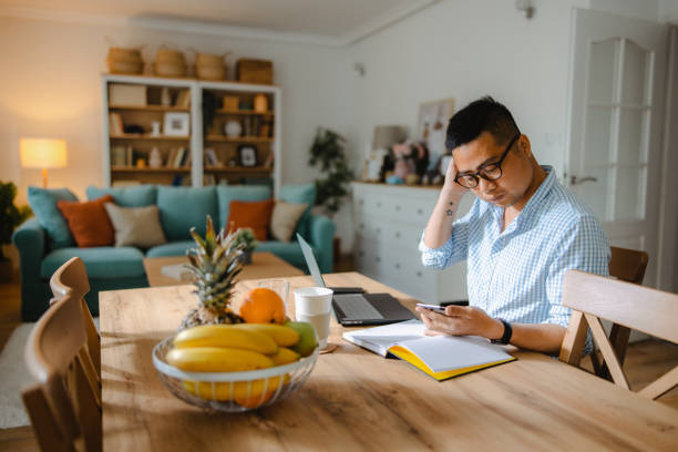 istock Asian male student studying at home 1490464386