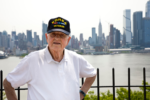 Korean War Veteran on a sunny day with New York City in the background.