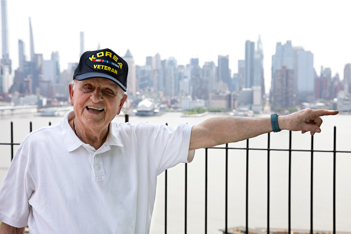 Korean War Veteran on a sunny day with New York City in the background.