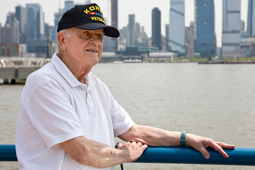 Korean War Veteran on a sunny day with New York City in the background.