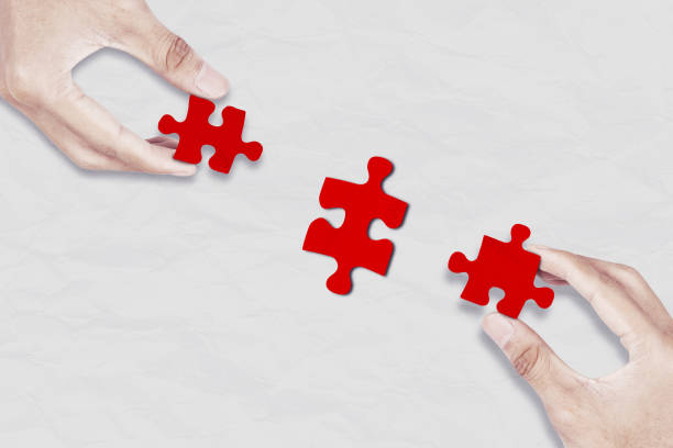 istock hold in hand a jigsaw puzzle. Business solutions, success and strategy 1490466880