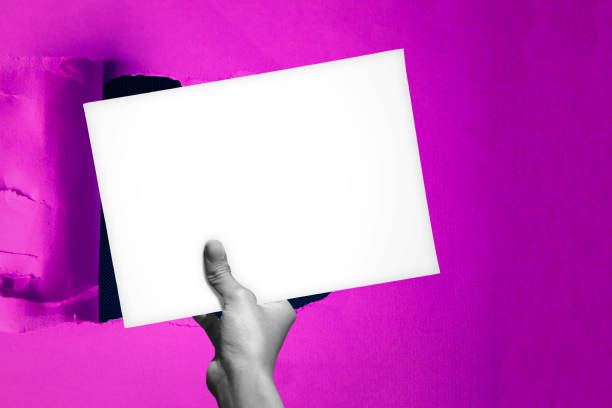 Blank empty paper in man hand covering up a hole in the background