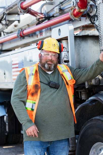 istock Concrete boom pump operator standing by truck door 1490467396