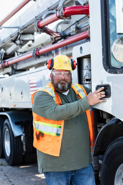 istock Concrete boom pump operator standing by truck door 1490467401