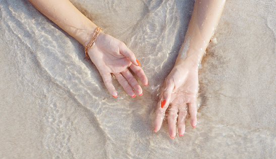 Hands concept for summer beach vacation