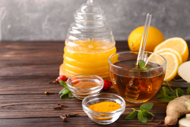 istock Tea with honey and ingredients on wooden table. Space for text 1490469633