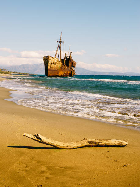 Cyprus Island Abandoned Cargo Shipwreck, Ghost Ship resting off the rocks near Rocks and Sea Caves North-West of Paphos. Moody sunset light. An 80m long shipwreck stranded in October 2011 on the way from Limassol towards Rhodes Island at the rocky Cyprus Mediterranean Sea Coast. Akamas Peninsula, Northern Paphos, South West Cyprus Island, Mediterranean Sea