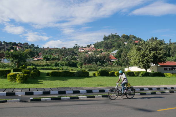 Kibuye, Rwanda – 01.04.2023: A man rides his bicycle through quiet streets during the coronavirus pandemic