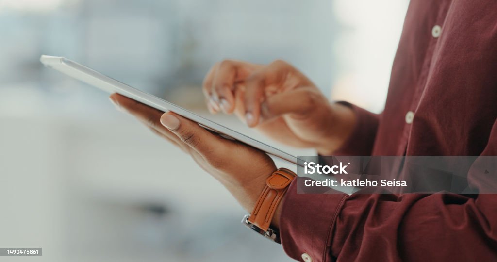 Closeup of man, tablet and hands in office for productivity, website planning and internet research. Male worker, digital technology and scroll app for online information, business data and analytics The Media Stock Photo