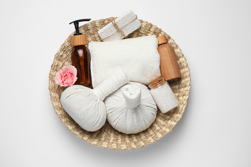 Beautiful spa composition with herbal massage bags and different care products on white background, top view