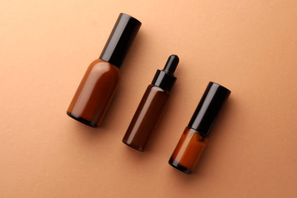 istock Bottles of face cream on beige background, flat lay 1490477588