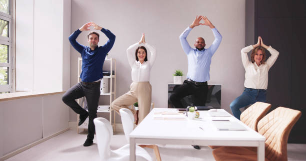 istock Businesspeople Standing In A Row Doing Exercise 1490481755