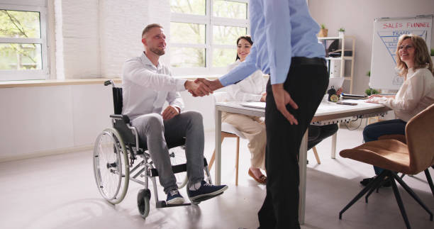 istock Person In Wheel Chair Handshake 1490481790