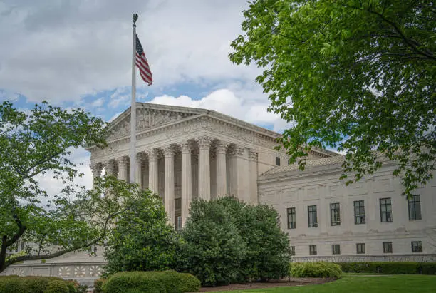 The Supreme Court Building in Washington D.C. during the spring season. Completed in 1935, the building serves as the home of the Supreme Court of the United States, the highest court in the land. Its neoclassical architecture and columns are a symbol of American justice and democracy.