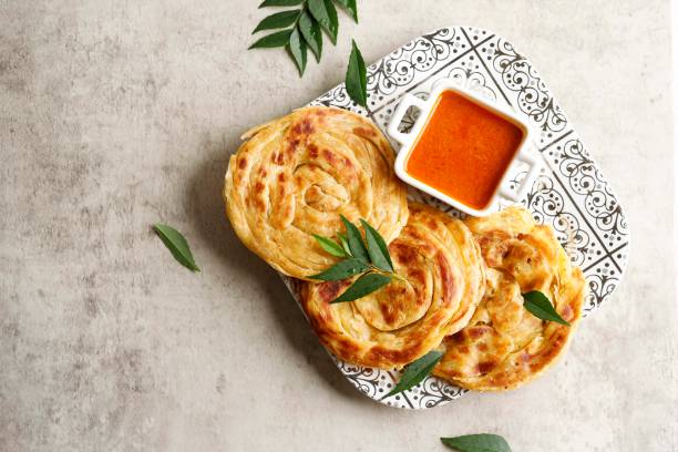 Homemade Paratha Bread with Curry Homemade Paratha Bread with Curry, Copy Space for Text roti canai stock pictures, royalty-free photos & images