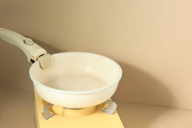 istock White Pan on Yellow Mini Stove, Cooking Preparation. 1490485428