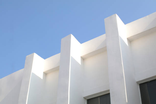 istock White Concrete Building Corner with blue sky. Minimal Shape Abstract Exterior Warehouse or Construction Element Concept 1490485587