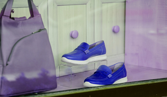 pair of women's blue shoes in a shop window in a store