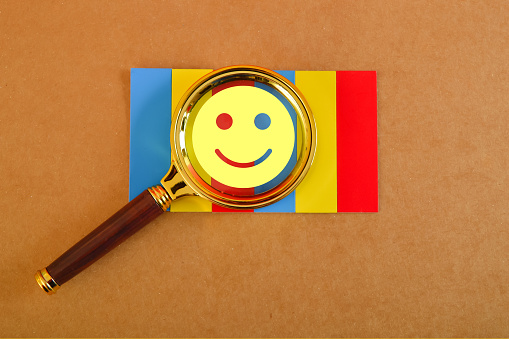 Magnifying glass with smile face emotion. Customer evaluation and satisfaction concept.