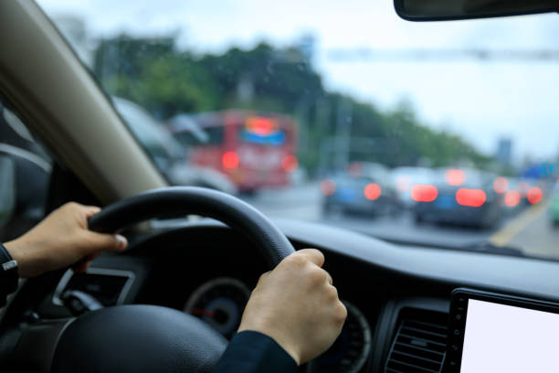 istock People driving car on city road 1490494365