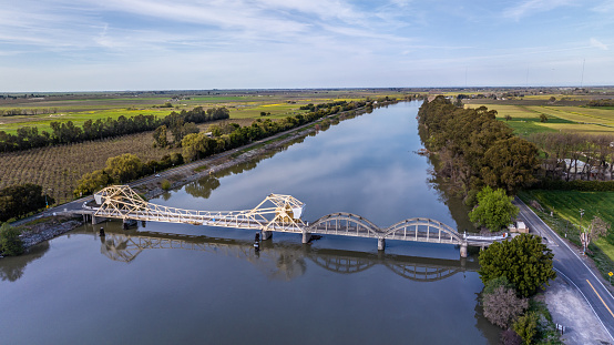 High quality aerial stock photo of the Isleton bridge crossing the Sacramento river near Rio Vista California.