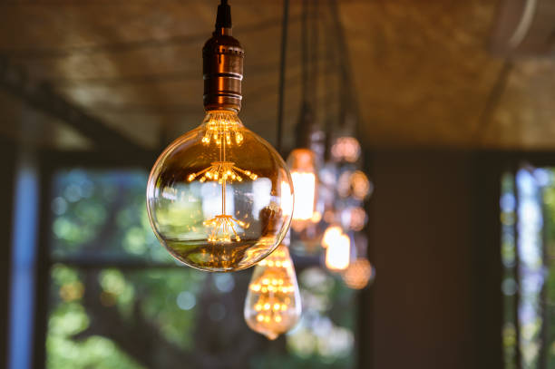 istock Beautiful vintage light bulb. Retro luxury light bulb hanging decor glowing. 1490497797