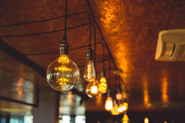 istock Beautiful vintage light bulb. Retro luxury light bulb hanging decor glowing. 1490498005