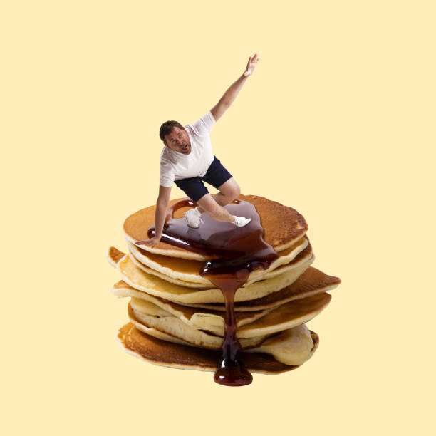 Man sliding on delicious pancakes with jam over yellow background. Carbohydrates food. Contemporary art collage