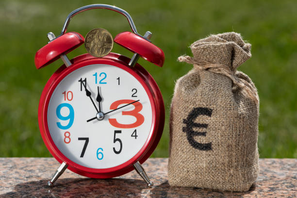 20 czk coin and red alarm clock - czech culture currency wealth coin imagens e fotografias de stock