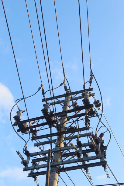 istock neatly organized electric poles and power cables with a bright blue sky background 1490503230