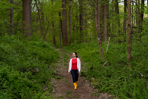 istock Latin woman walking in nature wearing yellow rain boots 1490503977