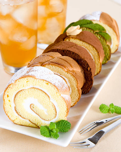 Slice of sweet swiss roll cake stock photo