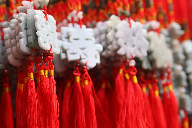 Chinese knot pendant, with seeds tied underneath and words of blessing or auspiciousness written on the seeds, traditional oriental handicraft