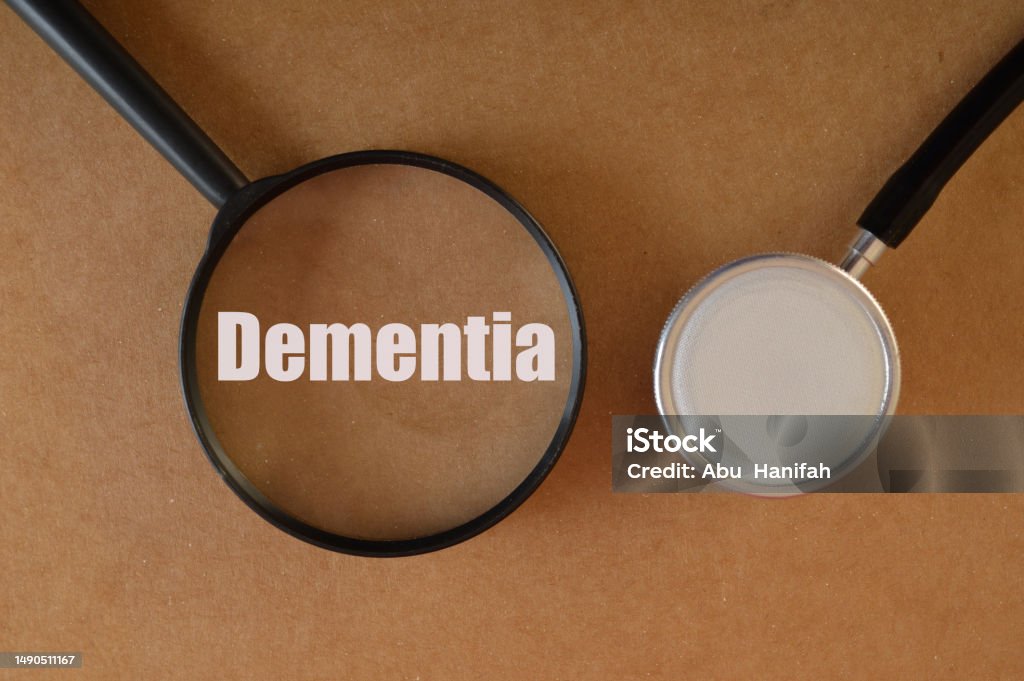 Stethoscope with text DEMENTIA. Dementia is a syndrome or group of symptoms that affect memory, thinking, behavior, and the ability to perform everyday activities Alzheimer's Disease Stock Photo