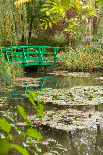 Home of impressionist artist Claude Monet showing the famous water lillies and Japanese bridge.