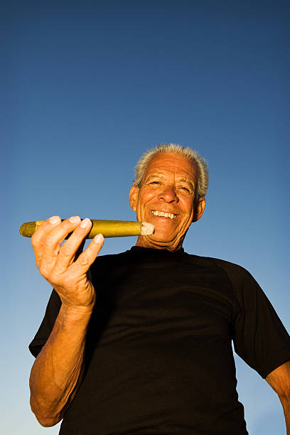 Large Stoogie A man and his big cigar or "stoogie" cuban man smoking big cigar stock pictures, royalty-free photos & images