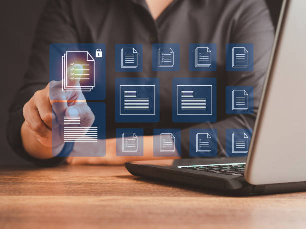 istock Businessman working at a laptop and digital documents with checkbox lists on virtual screen. 1490518001