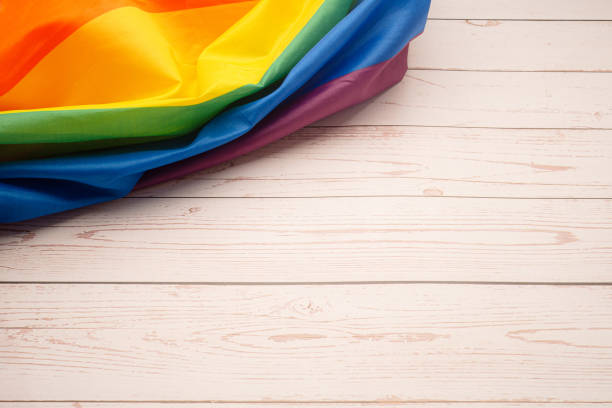 istock The rainbow flag or LGBT flag on a wooden table with copy space. 1490518087