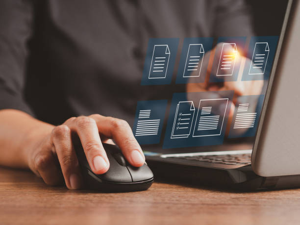 istock Businessman working at a laptop and digital documents with checkbox lists on virtual screen. 1490518783